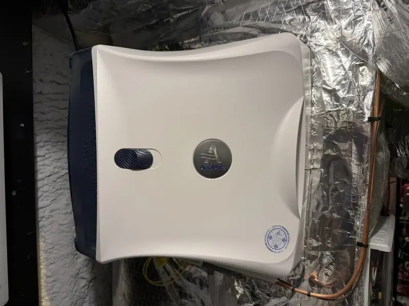Aprilaire fan-powered humidifier mounted on supply ductwork in a Southern NH home by A.J. LeBlanc Heating