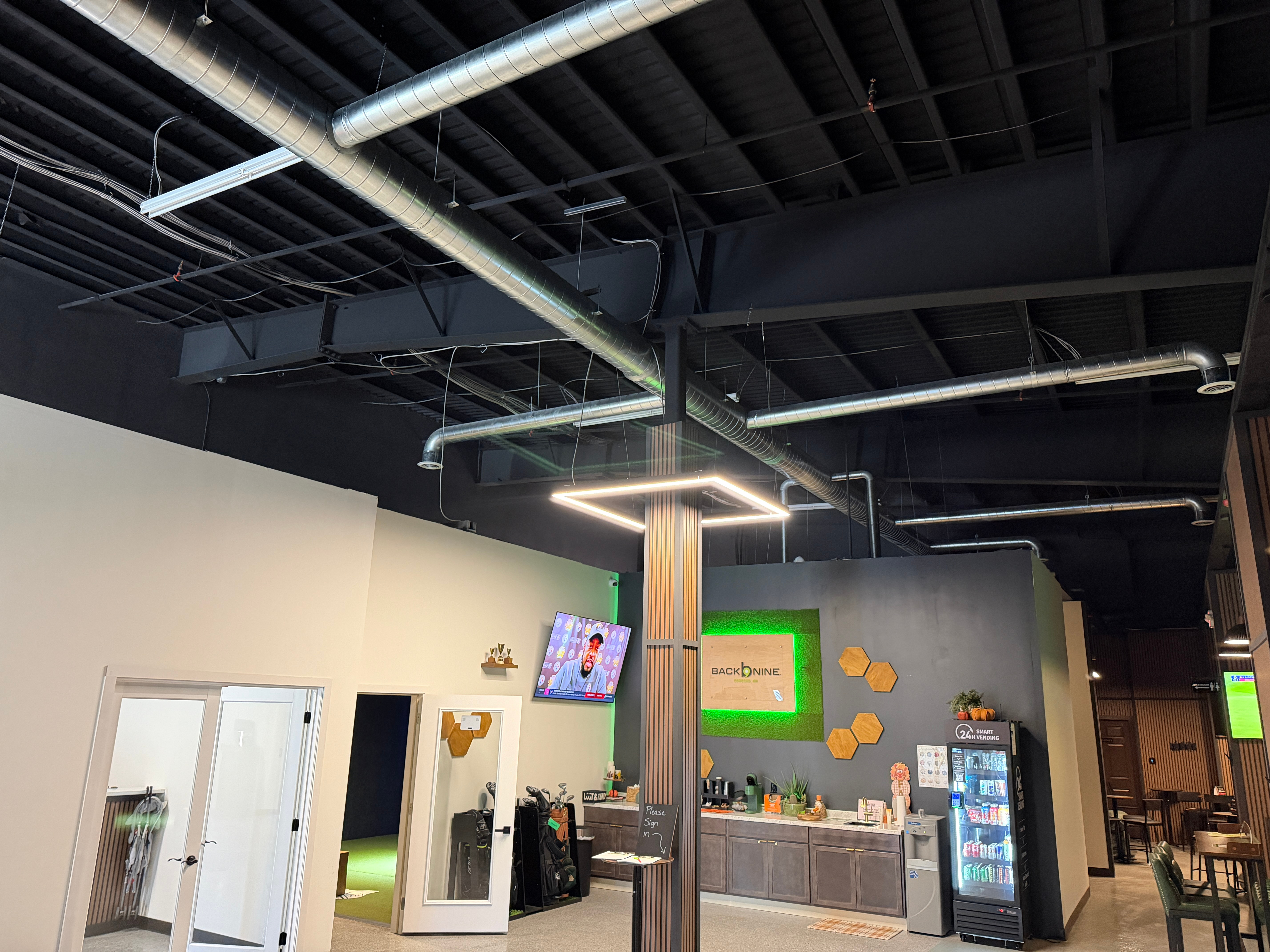 Spiral ductwork and branches across the exposed ceiling at Back Nine in Concord, New Hampshire