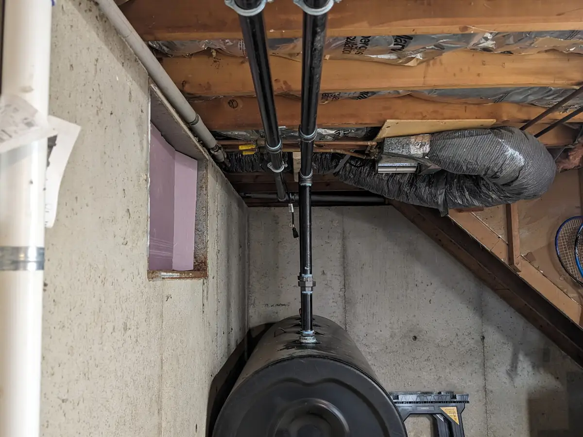 Black 275-gallon heating oil tank in a New Hampshire basement installed by A.J. LeBlanc Heating