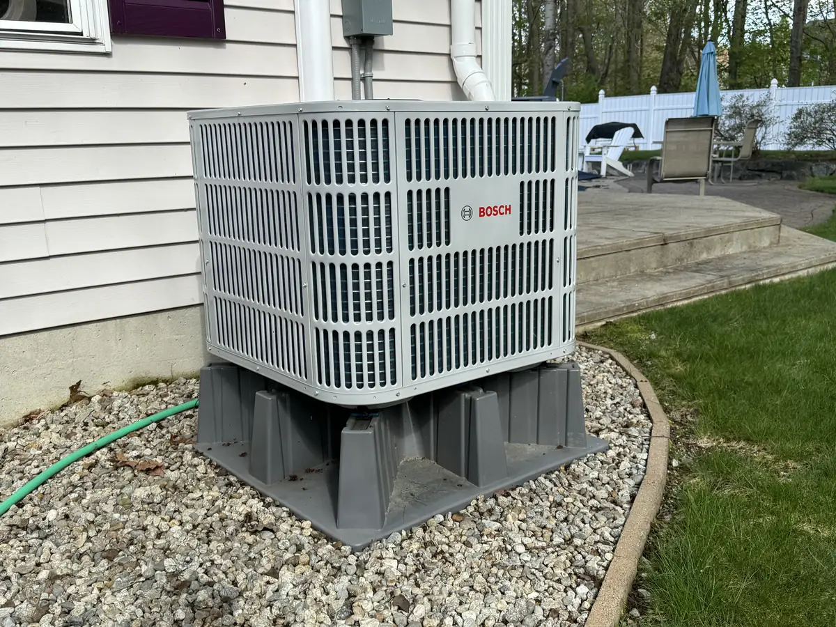 Bosch central air conditioner condenser installed in Southern NH residential yard