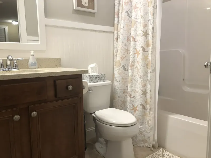 Two-piece toilet installed by A.J. LeBlanc Heating in a coastal-style Southern NH bathroom