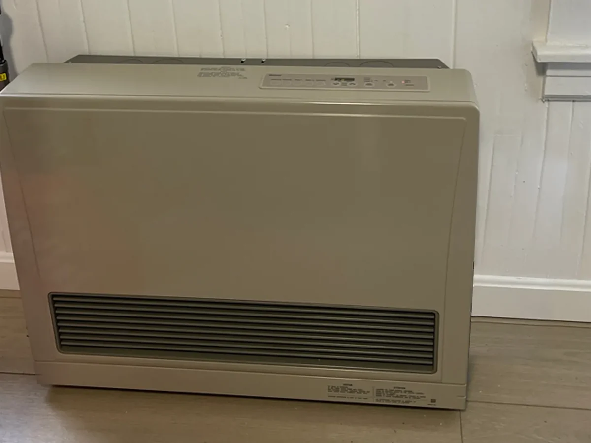 Direct-vent gas space heater console installed against an exterior wall of a Southern NH home by A.J. LeBlanc Heating