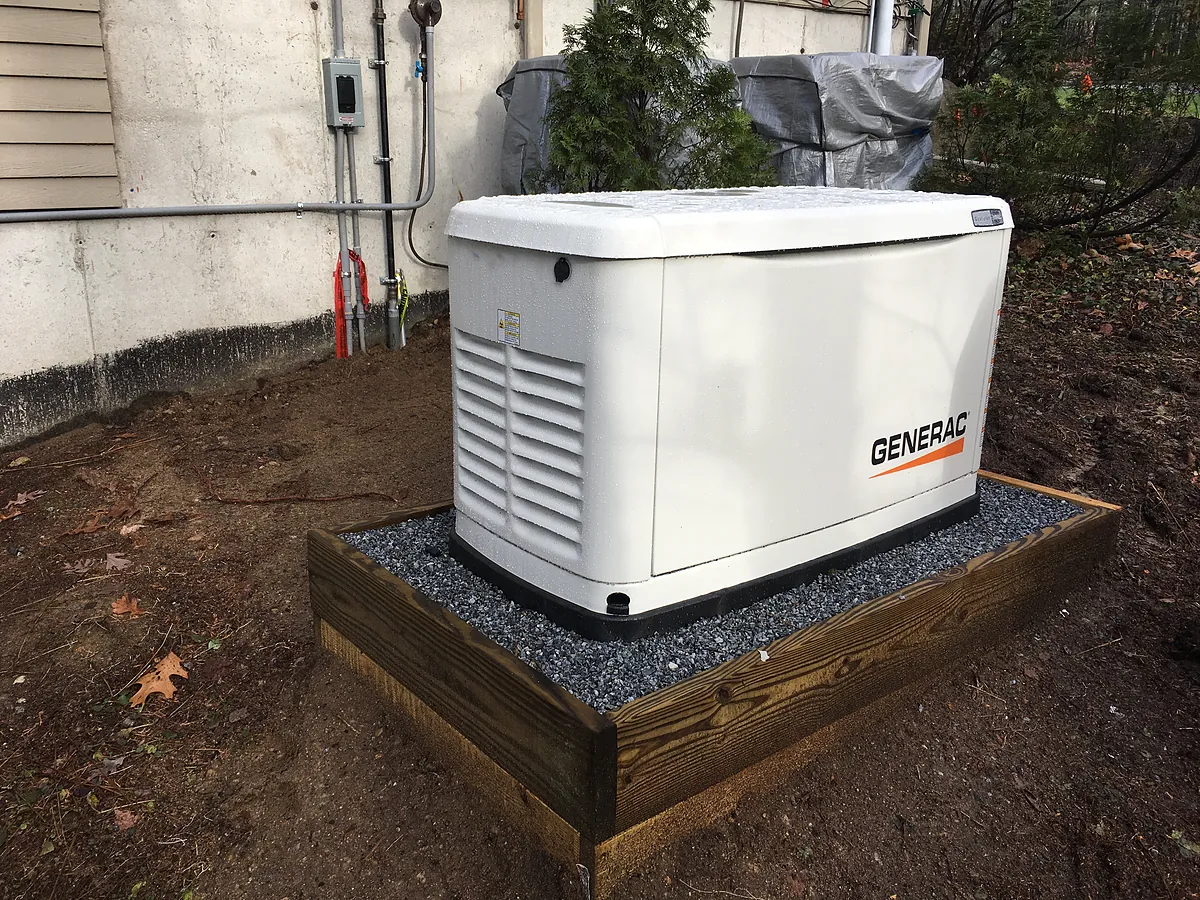 Generac standby generator installation on a gravel pad in Southern NH