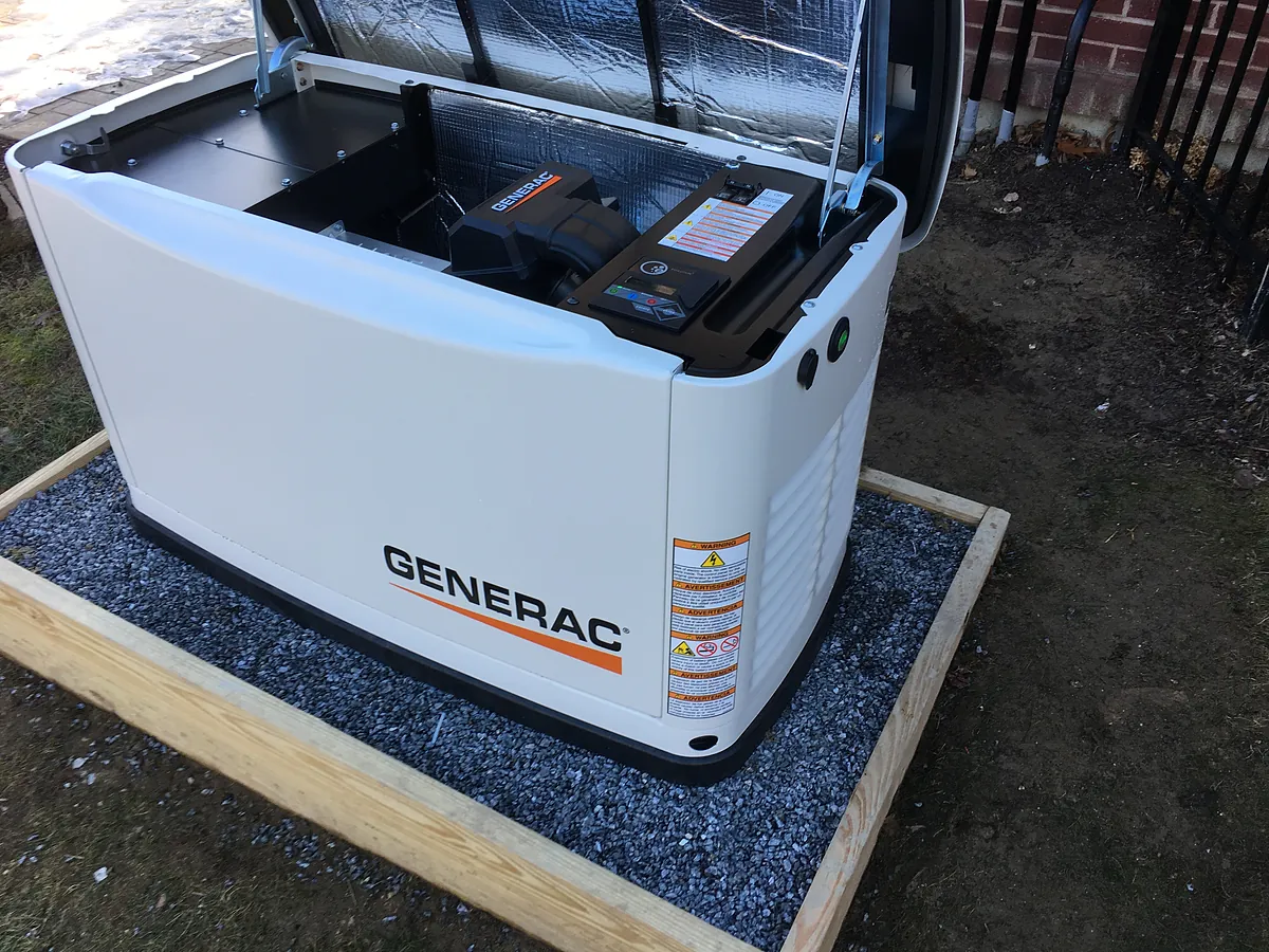 Generac whole-home standby generator installation with the hood open showing the engine, by A.J. LeBlanc Heating licensed electricians in Southern NH