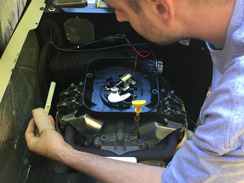 A.J. LeBlanc Heating technician performing a valve adjustment on a residential standby generator in Southern NH