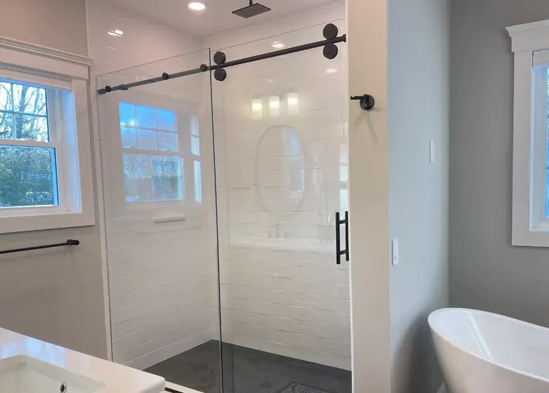 Large subway tile shower with plumbing and fixture connections completed by A.J. LeBlanc Heating in a Southern NH home