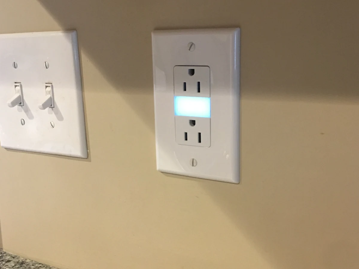Smart dimmer switch and tamper-resistant outlet installed side by side by A.J. LeBlanc Heating in a Southern NH home