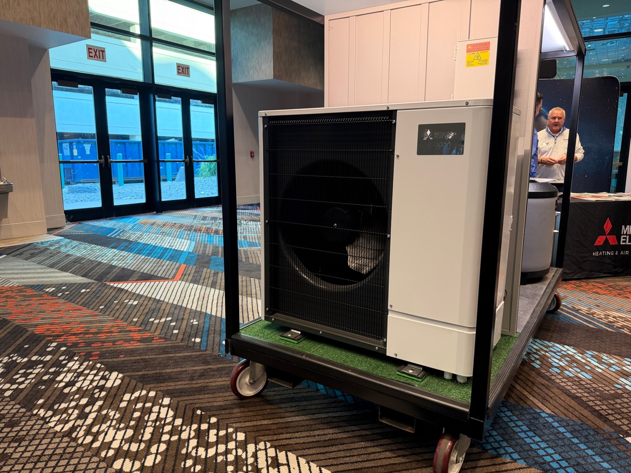 Mitsubishi Electric Ecodan outdoor heat-pump unit on a trade-show display.