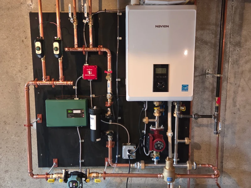 Navien wall-hung condensing gas boiler installation with copper manifold in Southern NH