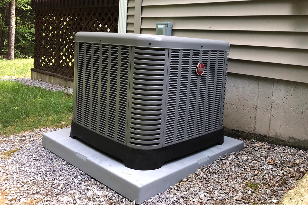 Outdoor A/C condenser installation in Southern New Hampshire