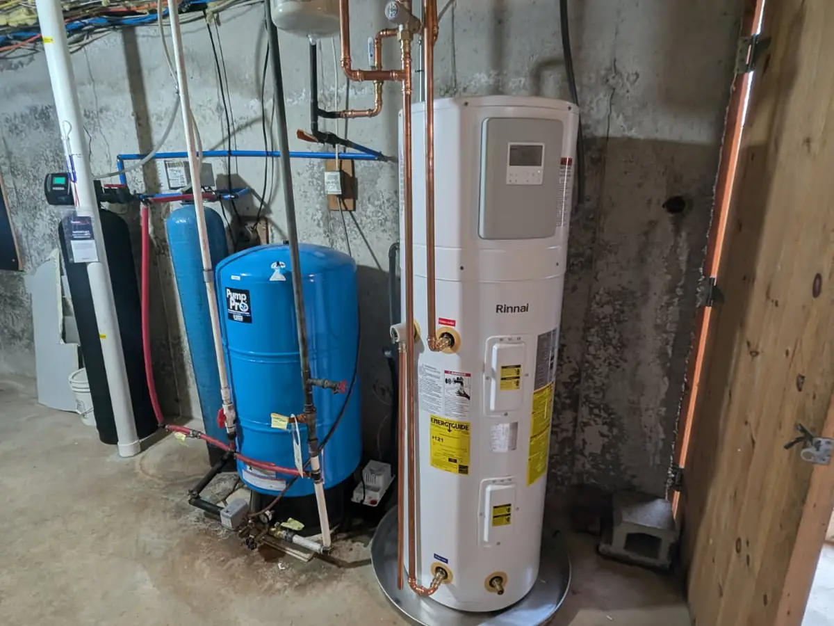 Rinnai hybrid heat pump water heater installation by A.J. LeBlanc Heating licensed plumbers in a Southern NH basement