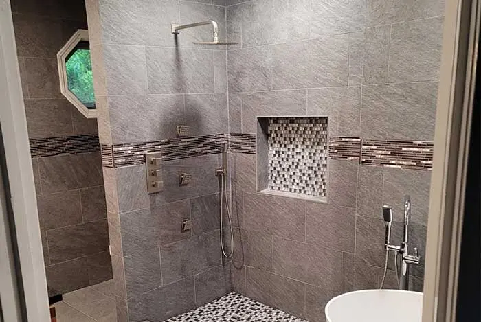 tile shower with black rain shower head