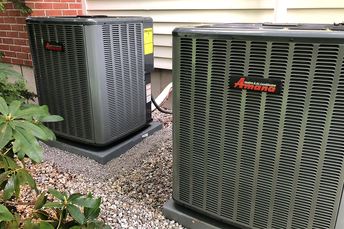 Two outdoor air conditioner condensers installed in Southern New Hampshire