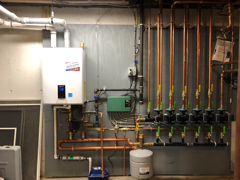 Wall-hung condensing boiler with multi-zone copper hydronic manifold, Southern NH